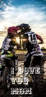 Motocross riders embrace at sunset with 'I Love You Mom' text.