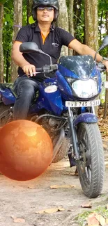 Man on motorbike in autumn forest with a surreal floating orb.