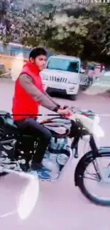 Man rides motorbike on city street with vibrant backdrop.