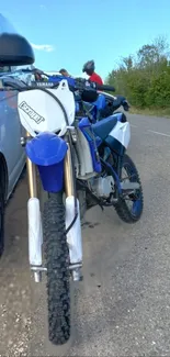 Motorbike on a scenic road with a vibrant blue sky backdrop.