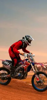 Motorbike rider on dirt track with sunset background.