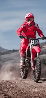 Motorbike rider on dirt trail in scenic landscape.