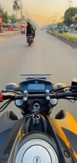 Motorbike on urban road at sunset with scenic view.