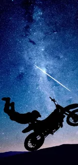 Silhouetted motorbike with starry night sky backdrop.