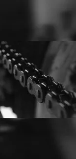 Close-up of a motorcycle chain in black and white.