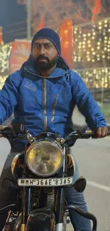 Man riding motorcycle with city lights at night, wearing a blue jacket.