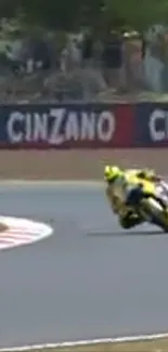 Motorcycle racer leaning into a fast curve on the track.