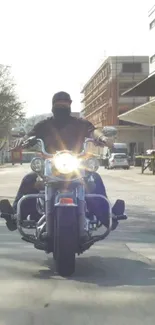 Motorcycle rider on a city street during the day.