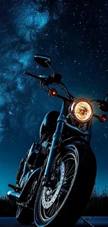 Motorcycle parked under a starry night sky.
