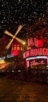 Moulin Rouge building with neon lights at night.