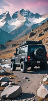 Jeep driving on rocky mountain trail under snowy peaks.