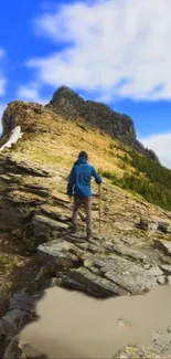 Hiker on a rocky mountain trail under vibrant blue sky.