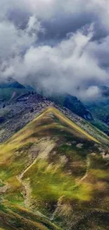 Mountain landscape with clouds and green peaks.