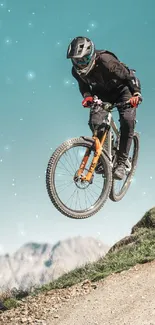 Cyclist performing a jump on a mountain bike with a scenic background.