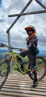 A biker on a mountain bike under a cloudy sky on a wooden platform.