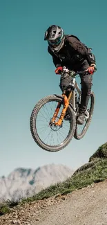 Mountain biker airborne over rugged terrain.