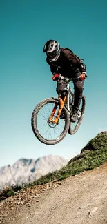 Mountain biker airborne against sky backdrop.