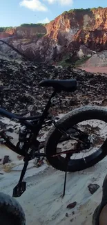 Bike on rugged terrain with mountain backdrop, perfect for adventure enthusiasts.