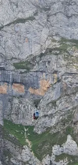 Cable car traversing stunning rocky mountain landscape.