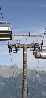 Cable car ascending over scenic mountain landscape with blue sky.