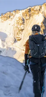 Climbers ascending a snowy mountain with gear at sunrise.