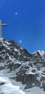 Snowy mountain peak with cross under starry night sky.