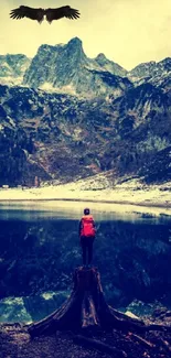 Adventurer by a mountain lake with an eagle overhead.