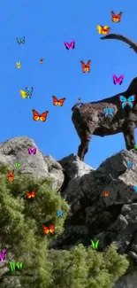 Mountain goat standing on rocky cliff under clear blue sky.