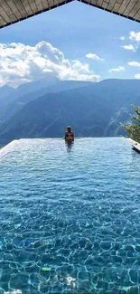 Infinity pool with mountain view and a serene sky backdrop.