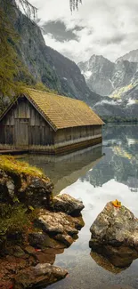 Serenely reflective lake with mountain cabin.