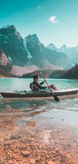 Person kayaking on a turquoise mountain lake with scenic views.