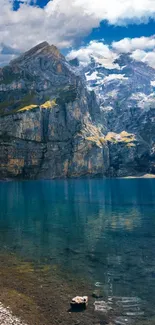 Scenic mountain lake with clear blue waters and rocky peaks under a bright sky.