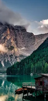 Scenic wallpaper of a tranquil lake with mountains and forests.