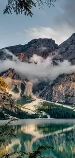 Scenic mountain lake with misty peaks and clouds in a calming nature setting.