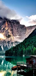 Mountain lake with cabin and forest reflection.