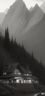 A mountain lodge nestled in misty gray mountains under a serene sky.