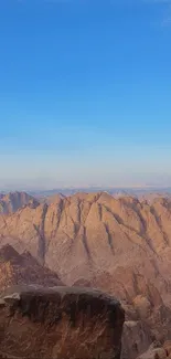 Mountainous landscape under a vibrant blue sky, perfect for phone wallpaper.