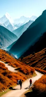 Mountain trail with hikers in vibrant autumn scenery.