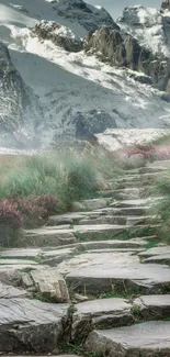 Scenic mountain path with snowy peaks and greenery.