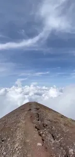 Mountain peak with clouds and blue sky wallpaper.