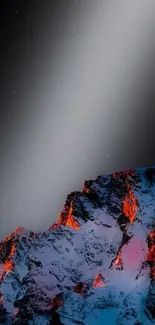 Snow-capped mountain peak under a starry night sky with glowing orange light.