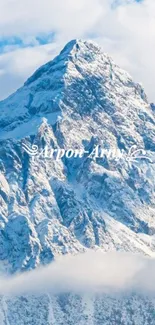 Majestic snowy mountain under a blue sky.