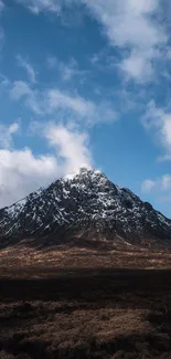 Snow-capped mountain under a blue sky.