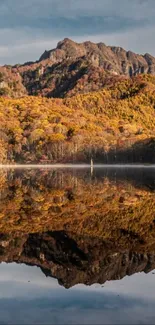 Autumn mountain landscape with serene lake reflection.