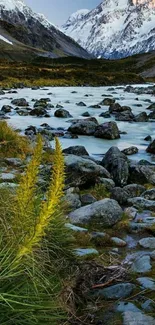 A serene mountain river with snow-capped peaks and lush greenery.