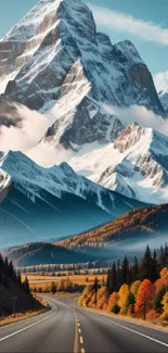 Scenic road with autumn trees and snow-capped mountains.