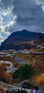 Scenic mountain road with dramatic sky and colorful landscape.