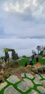 A breathtaking view from a mountain top with misty clouds and lush greens.