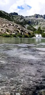 Serene mountain stream with peaceful water and rugged, majestic peaks.