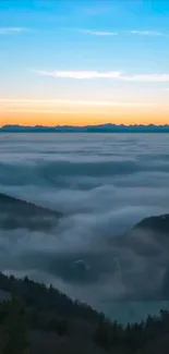 Sunrise over mountains with misty clouds.